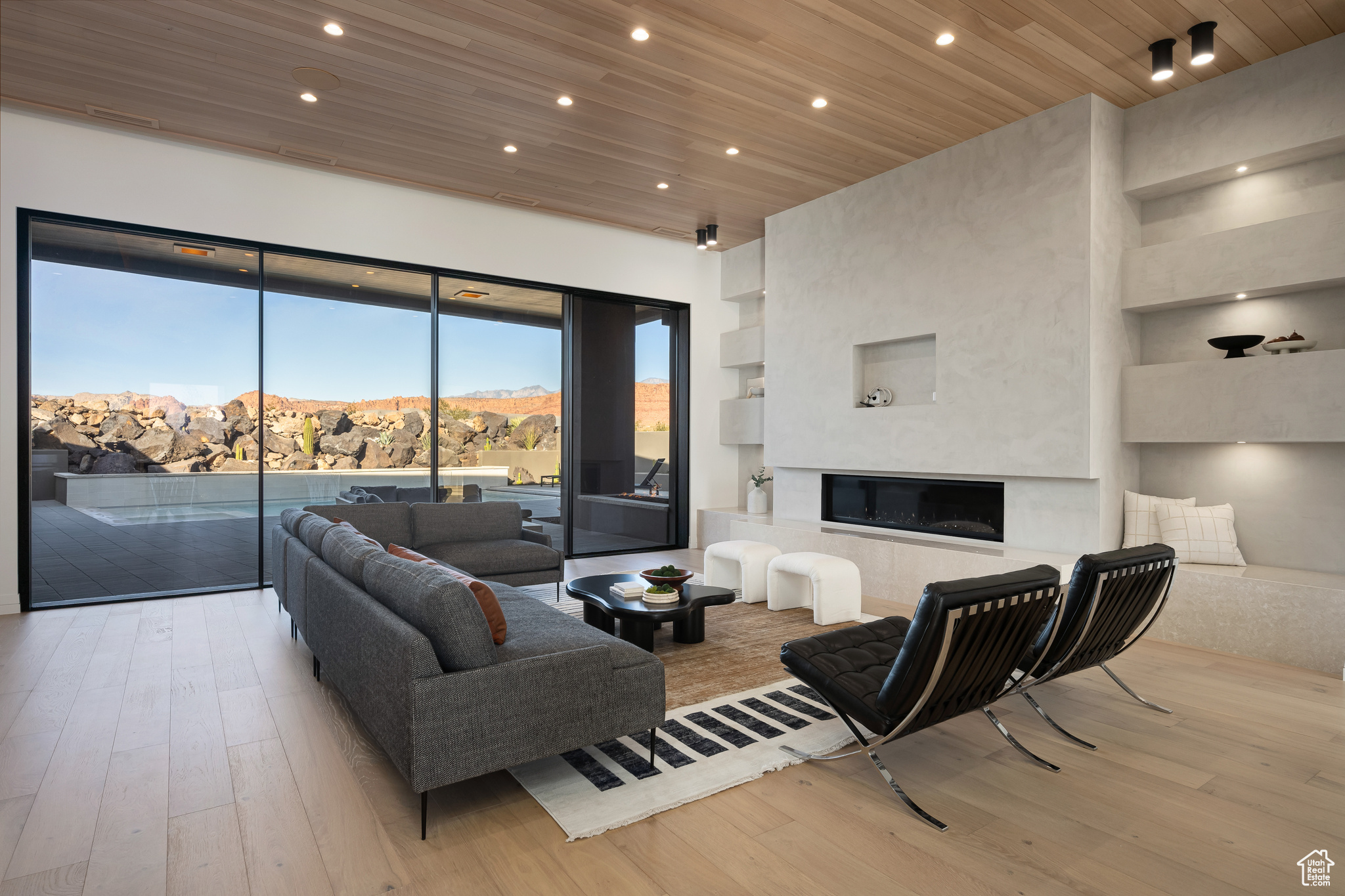 Living room with a mountain view, light hardwood / wood-style floors, and wooden ceiling