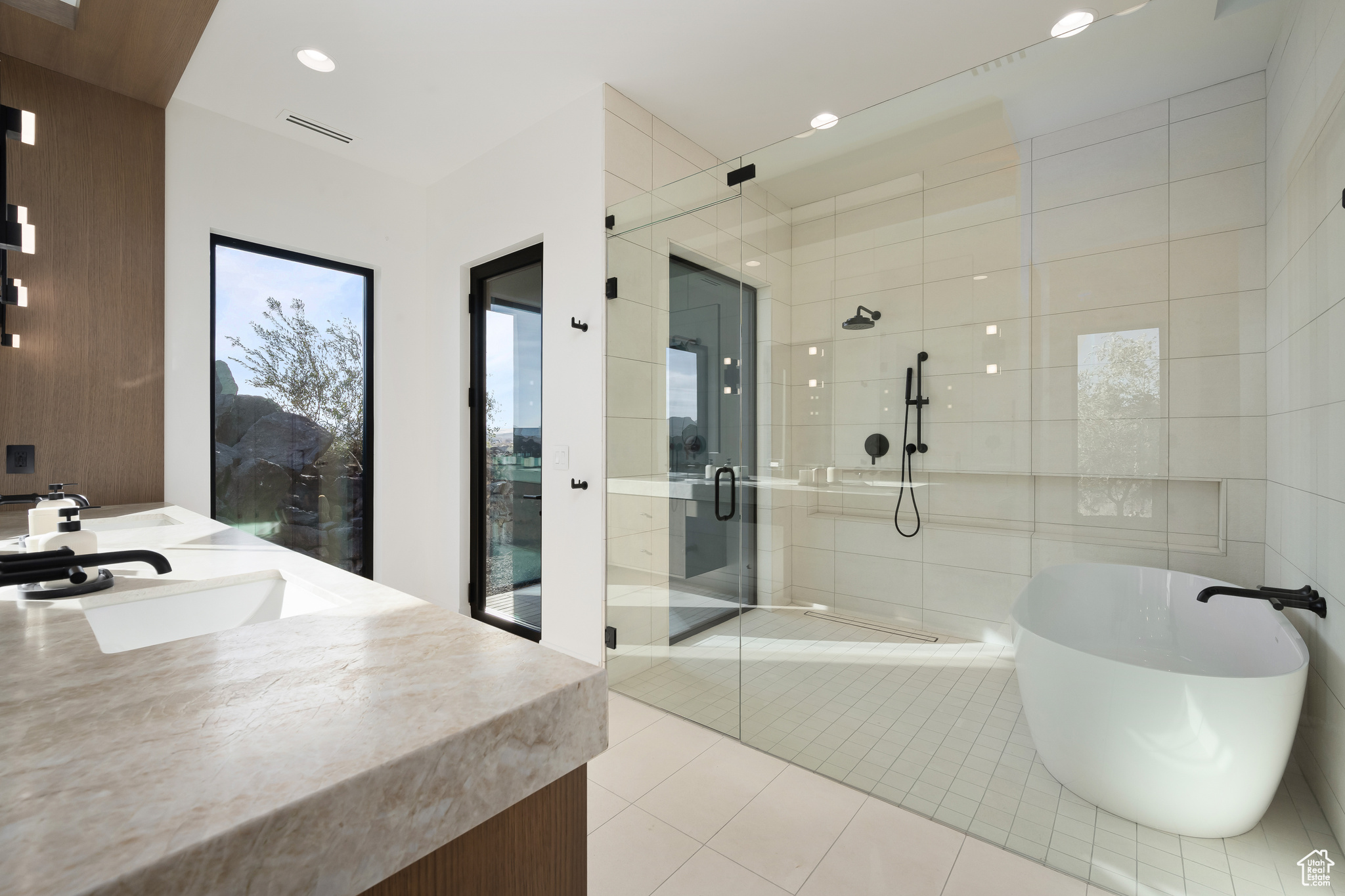 Bathroom with shower with separate bathtub, vanity, and tile patterned floors