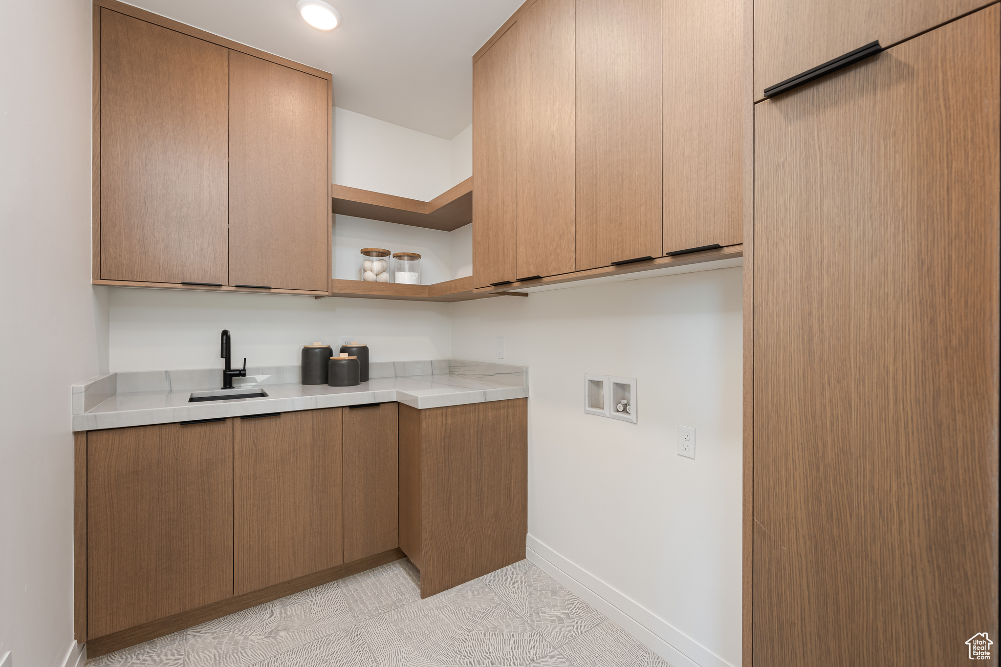 Kitchen featuring light tile patterned flooring and sink