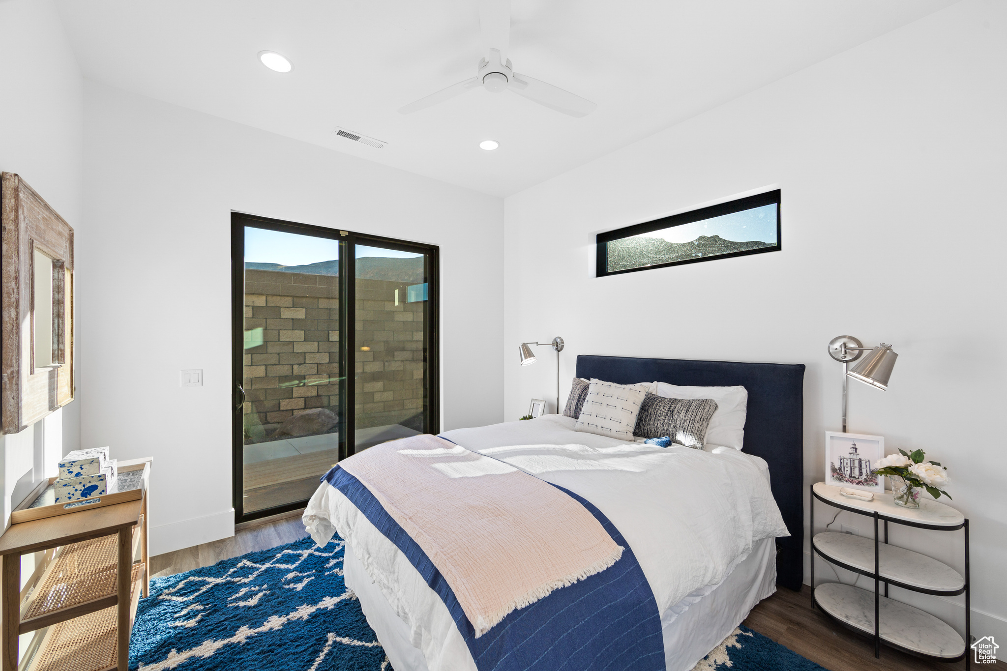 Bedroom featuring dark hardwood / wood-style floors, ceiling fan, access to outside, and multiple windows