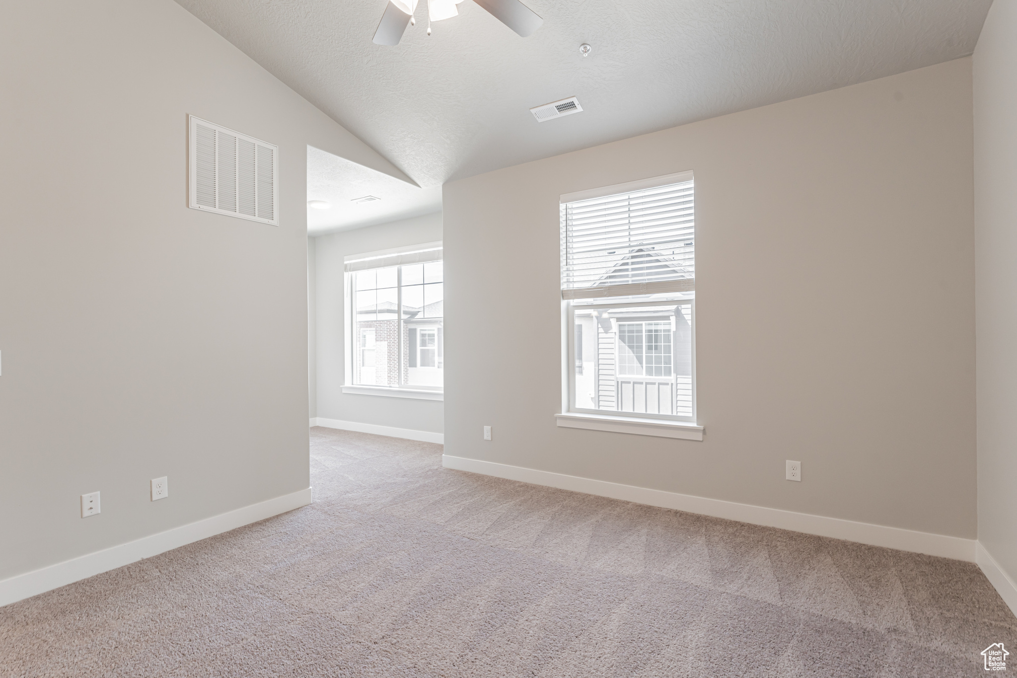 Unfurnished room with carpet, lofted ceiling, and ceiling fan