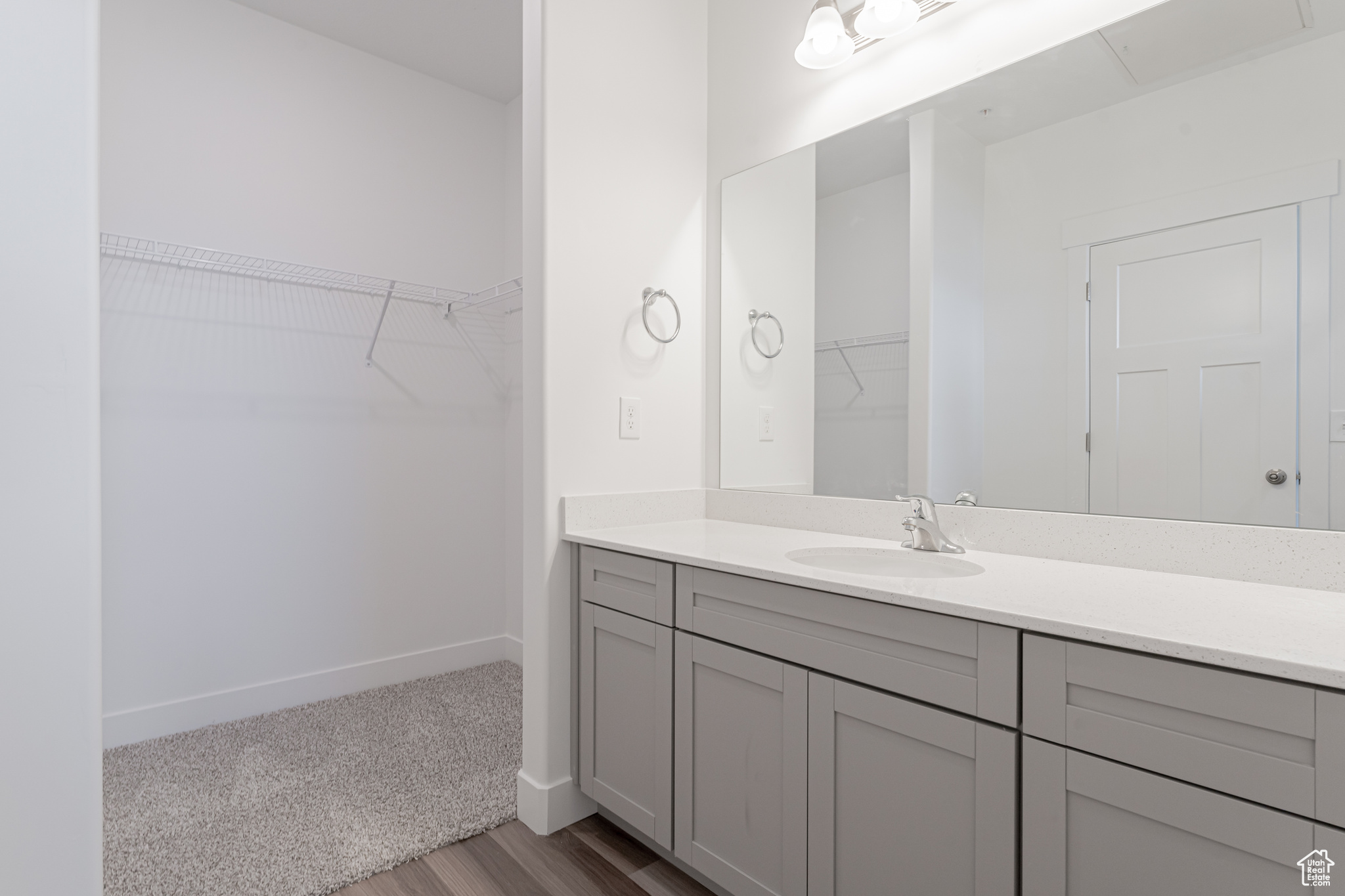 Bathroom featuring vanity and wood-type flooring