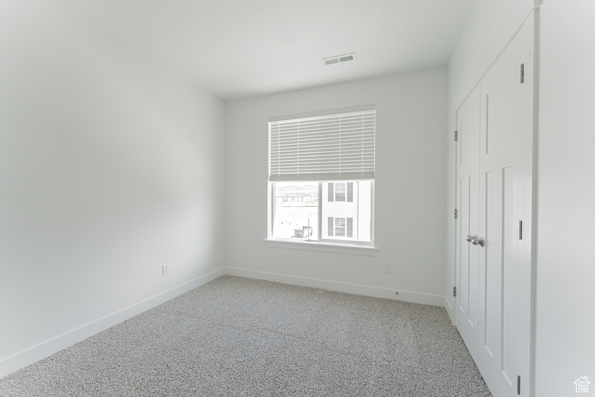 Unfurnished bedroom featuring light carpet