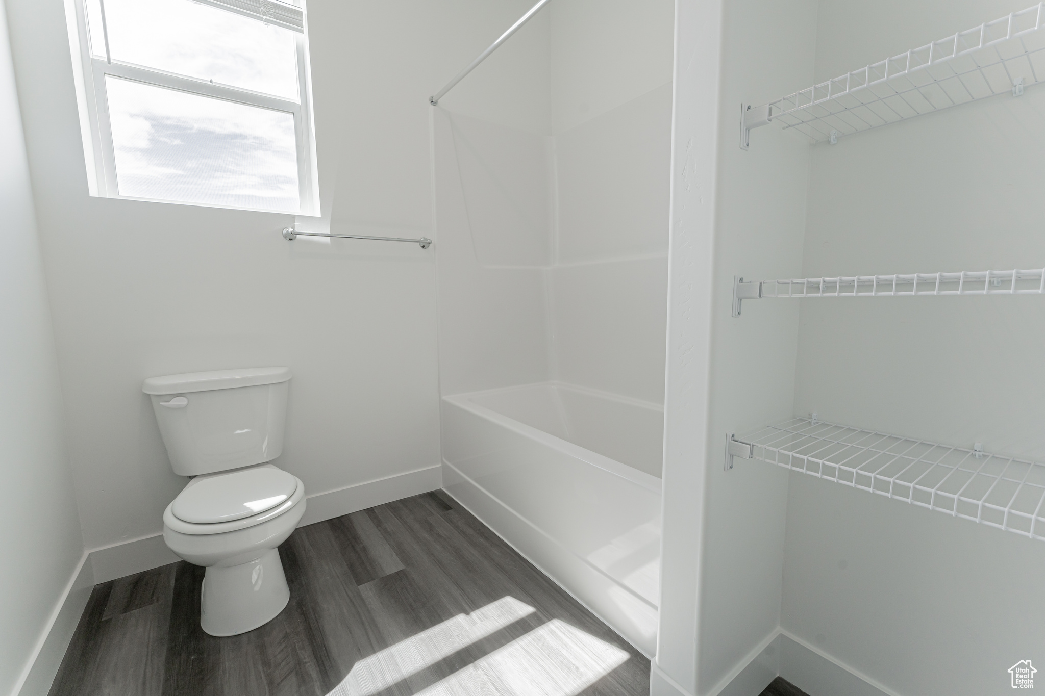 Bathroom featuring hardwood / wood-style flooring and toilet