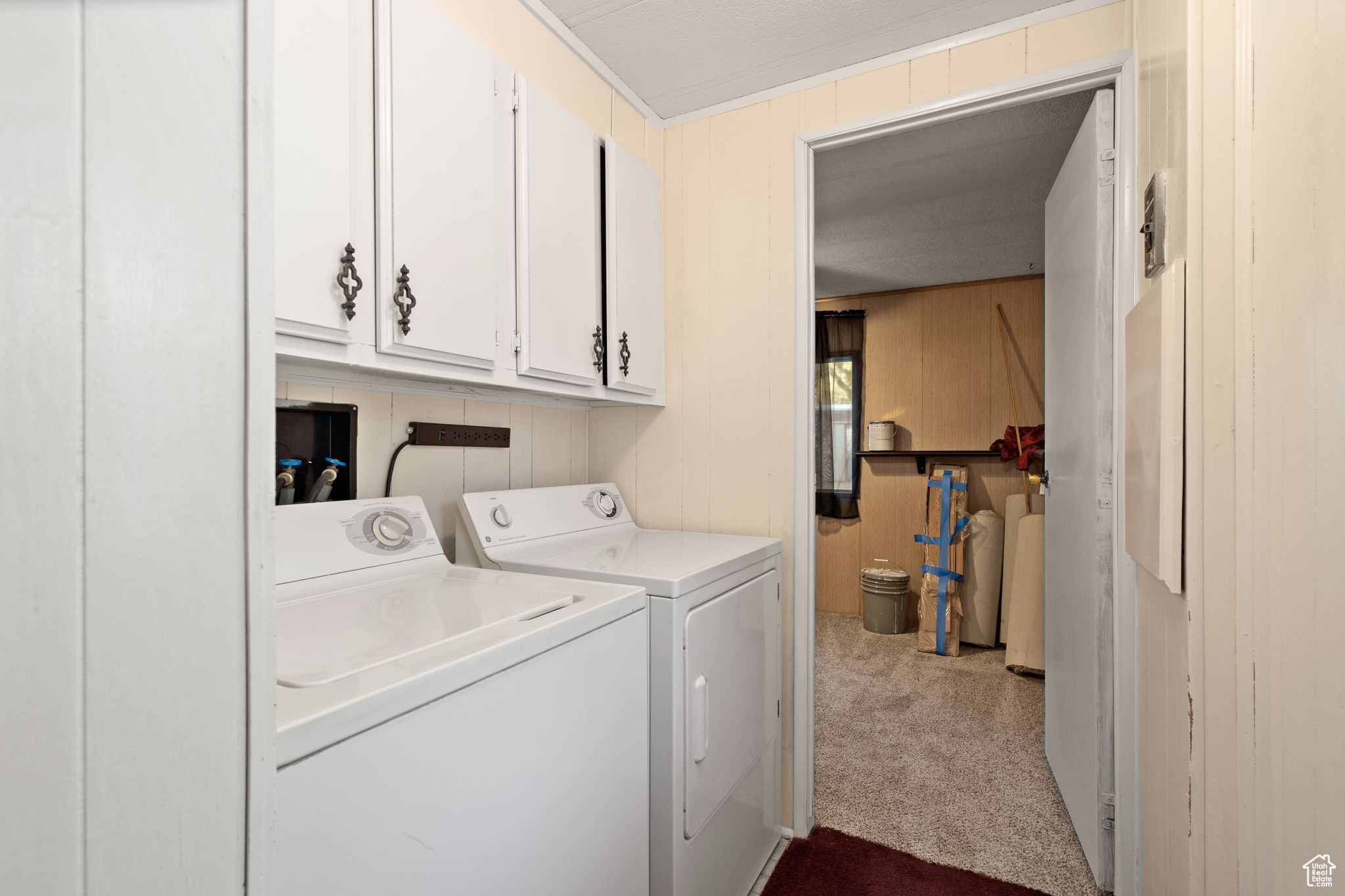 Laundry room featuring washer and dryer, hookup for a washing machine, cabinets, and light colored carpet