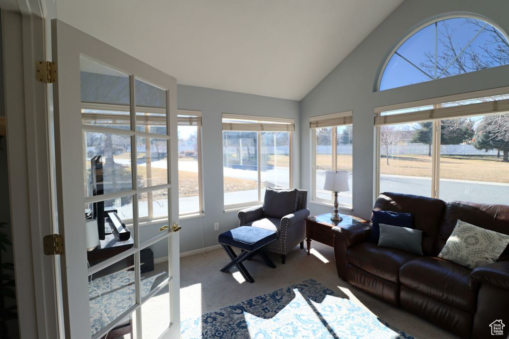 Sunroom featuring lofted ceiling