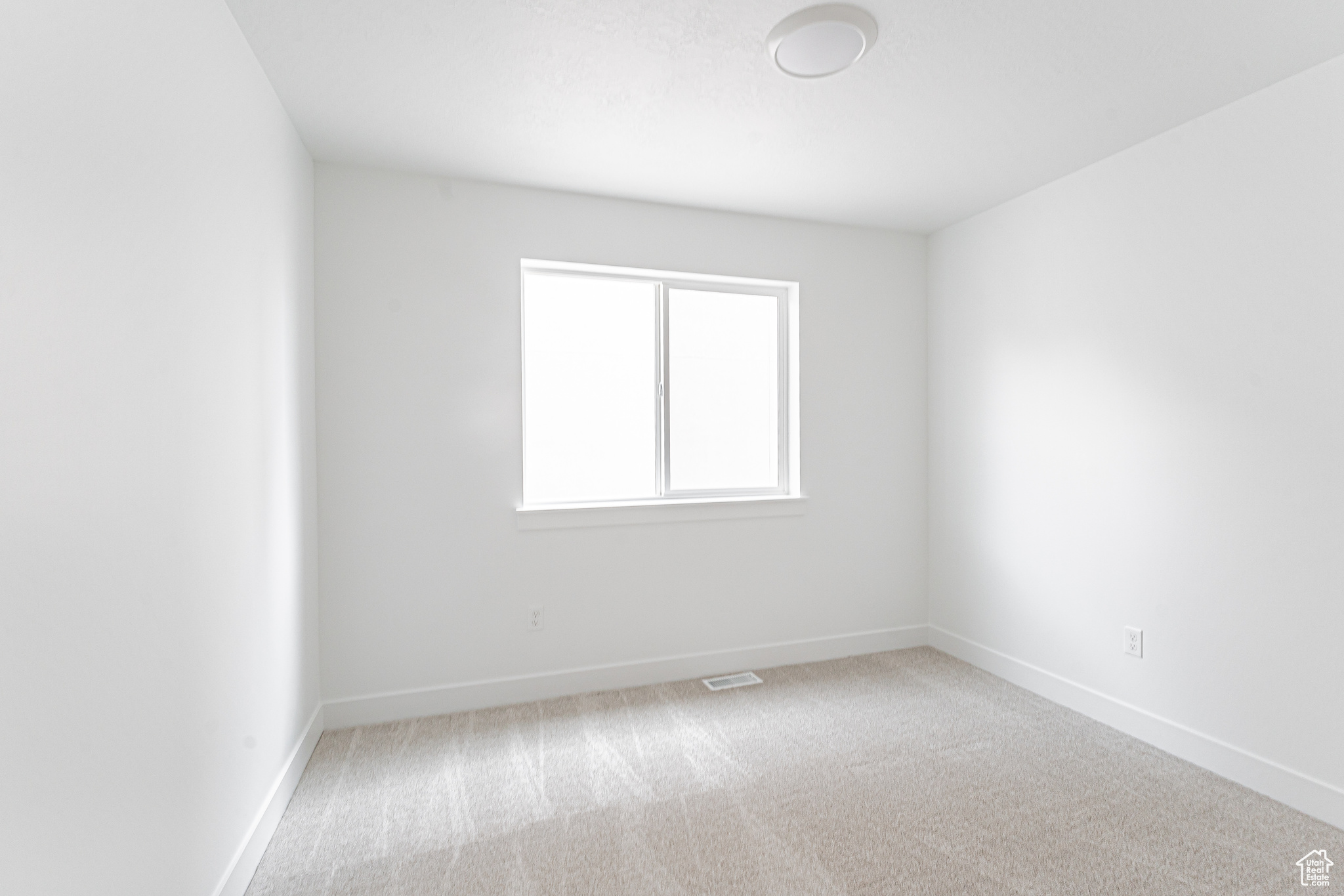 Spare room featuring carpet flooring