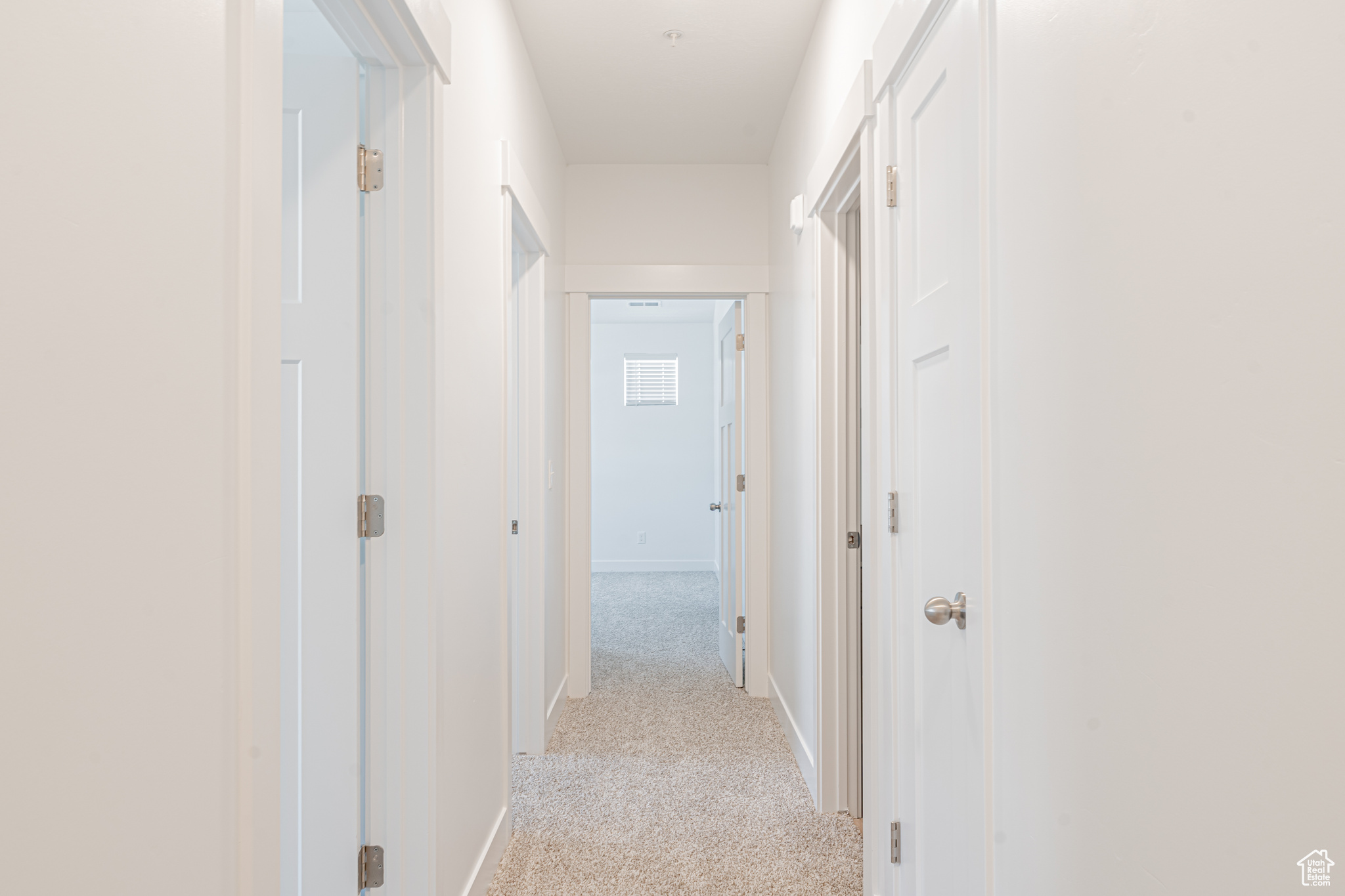 Corridor with light colored carpet