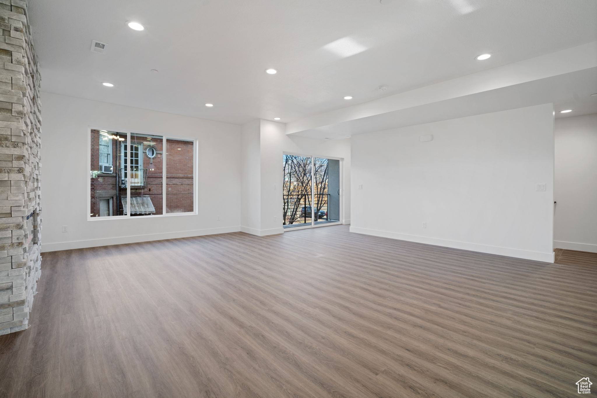 Unfurnished living room featuring dark hardwood / wood-style flooring