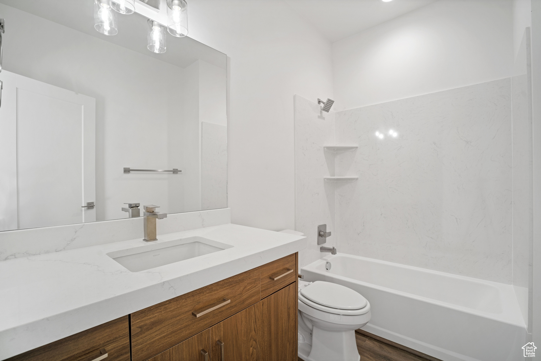 Full bathroom featuring toilet, shower / bathtub combination, oversized vanity, and wood-type flooring