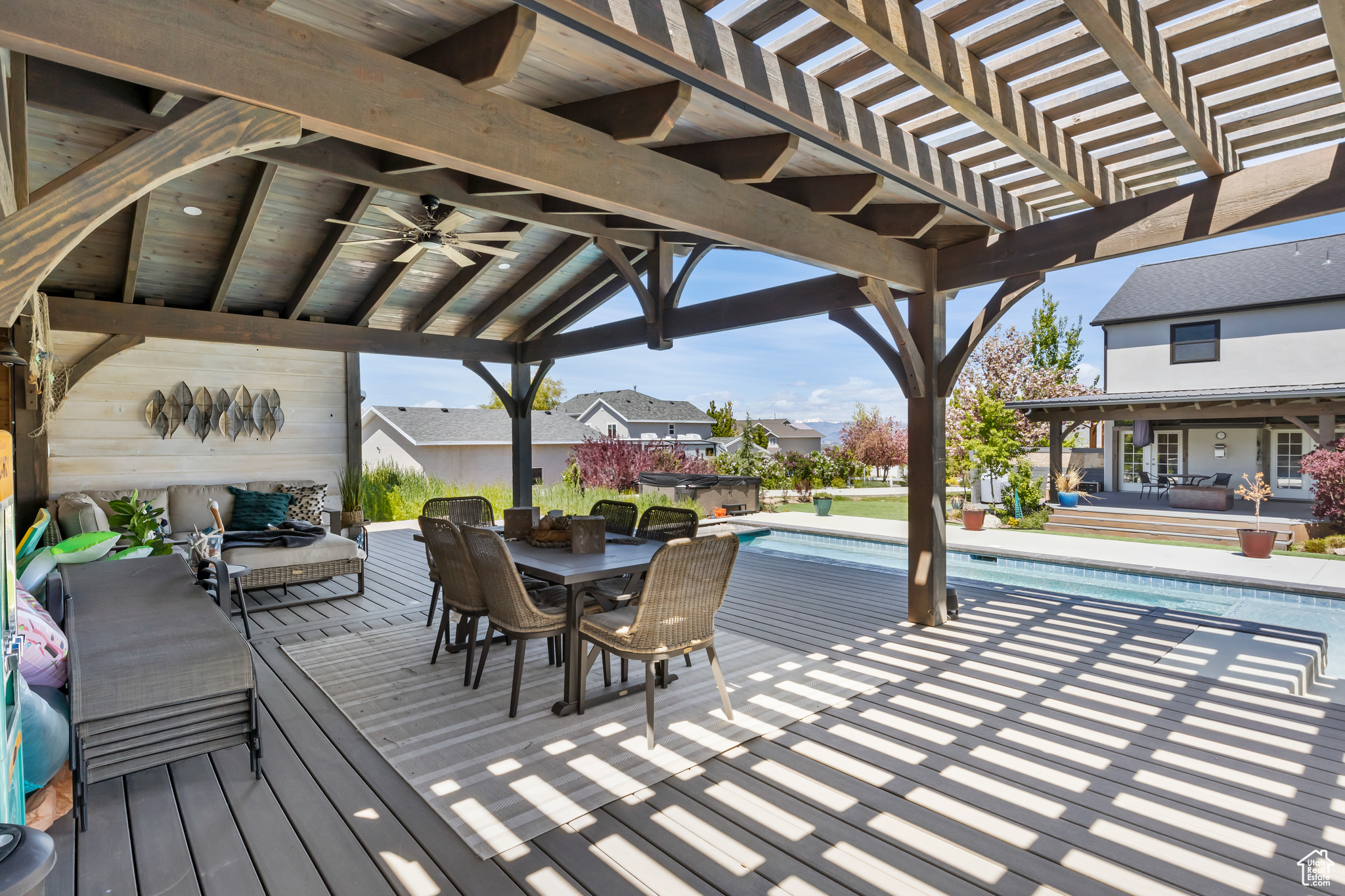 Exterior space featuring a fenced in pool, ceiling fan, and a pergola
