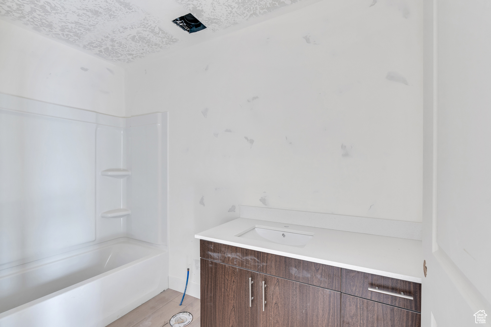 Hall bath with dark wood cabinets.