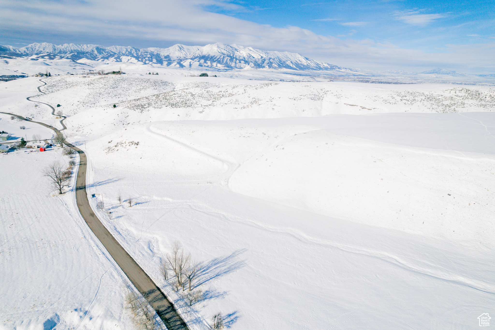 Snowy aerial view featuring a mountain view