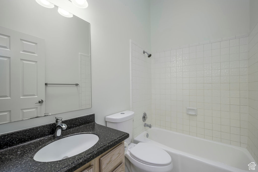 Full bathroom with shower / tub combo, vanity, mirror, a wealth of natural light, and light tile floors