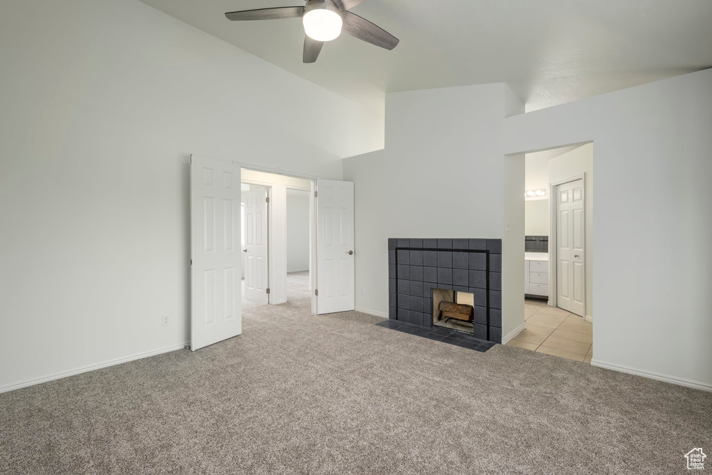 Bedroom featuring a fireplace, new carpet, and ceiling fan.