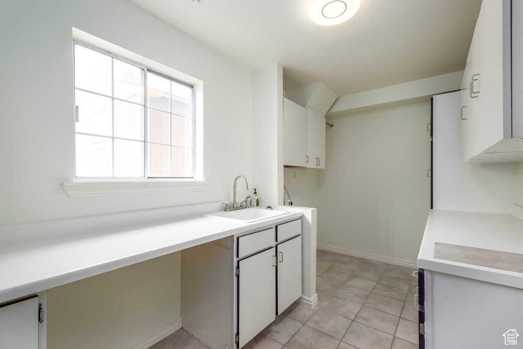 Washroom with ample cabinet storage space.
