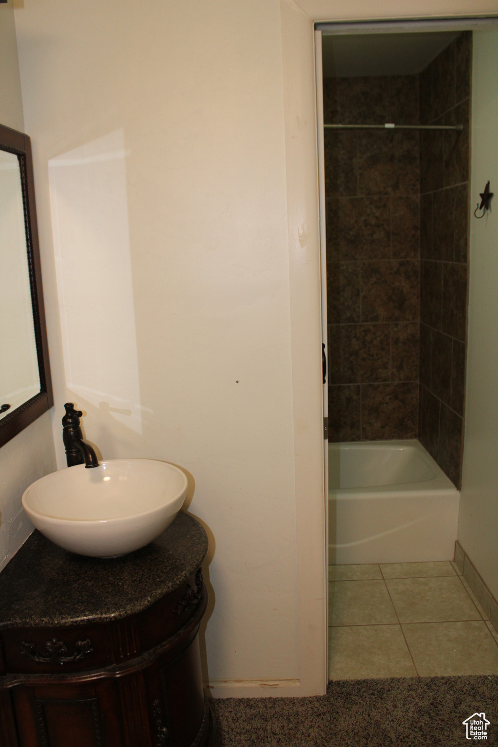Bathroom with vanity, tiled shower / bath, and tile flooring