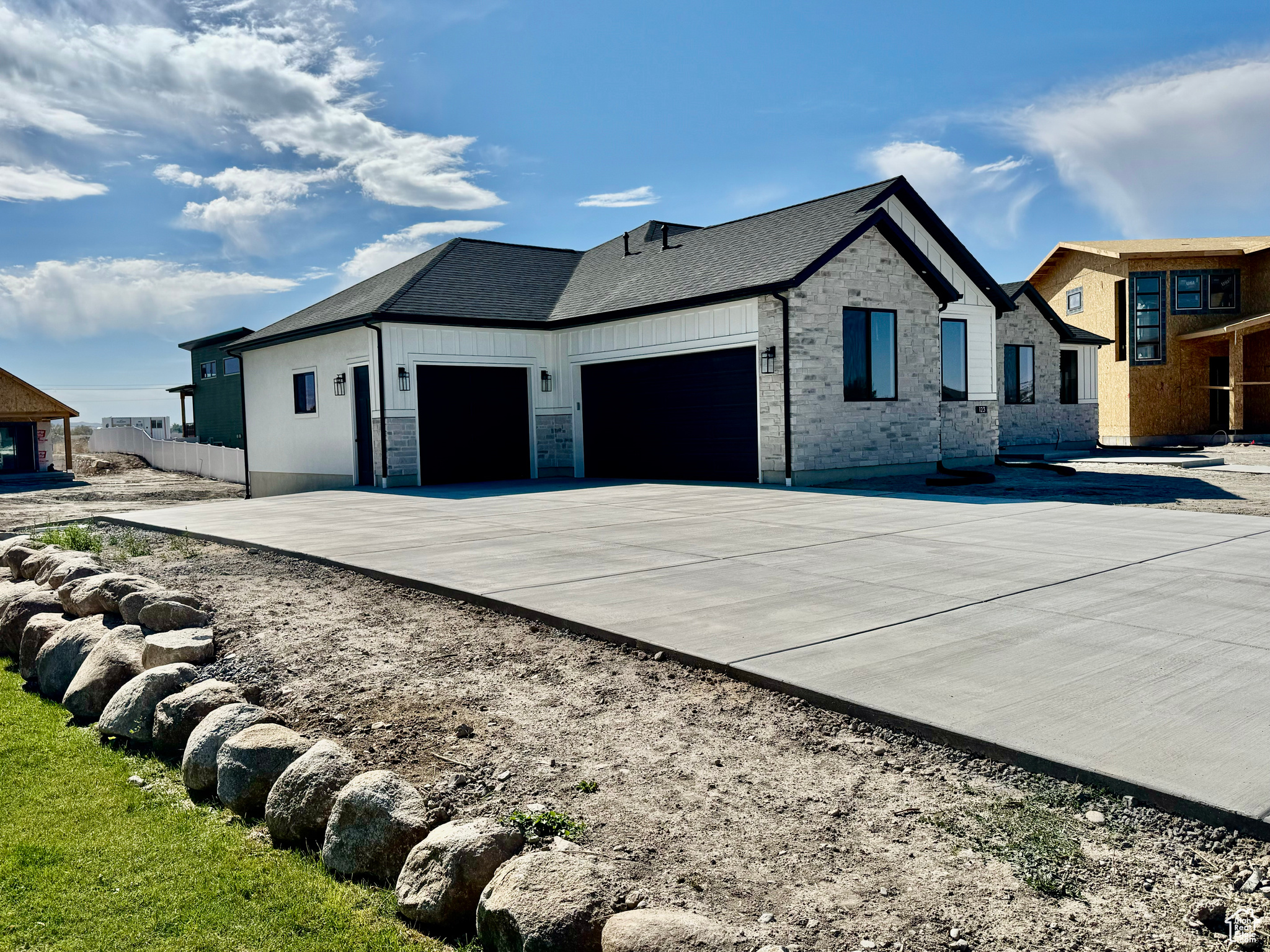 View of side of property with a garage