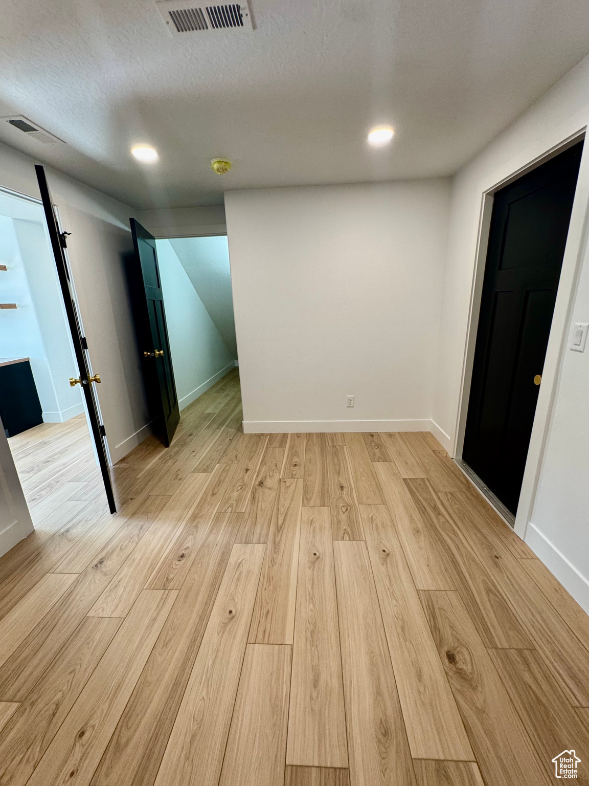 Spare room featuring a textured ceiling and light wood-type flooring