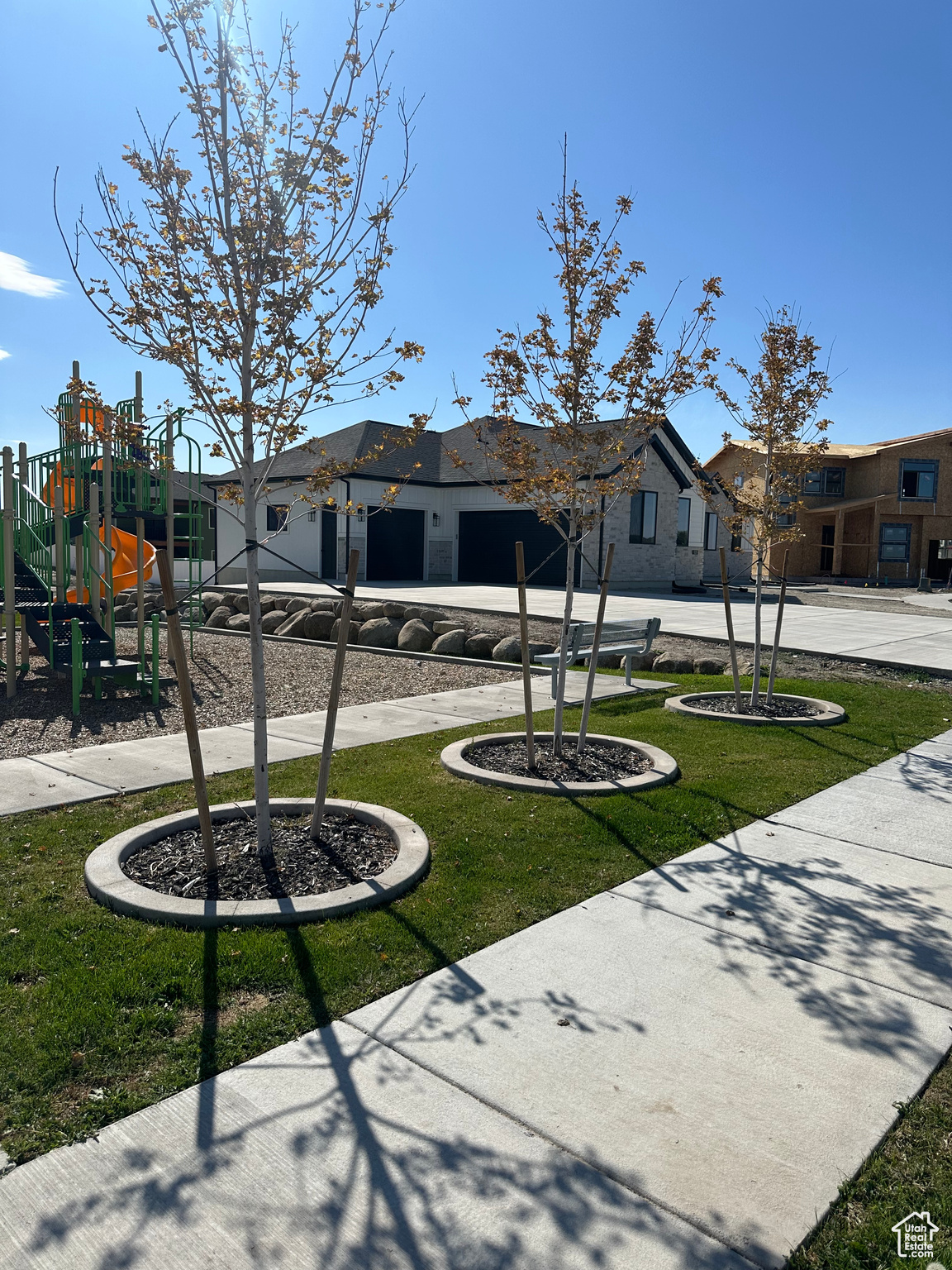 View of property's community with a playground and a yard