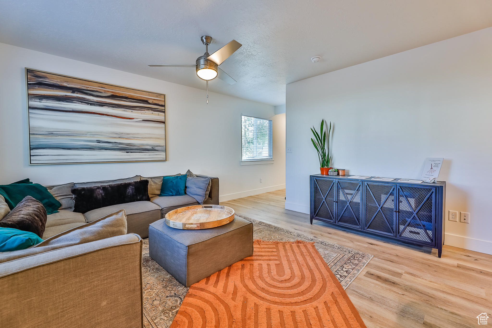 Living room featuring light hardwood / wood-style flooring and ceiling fan