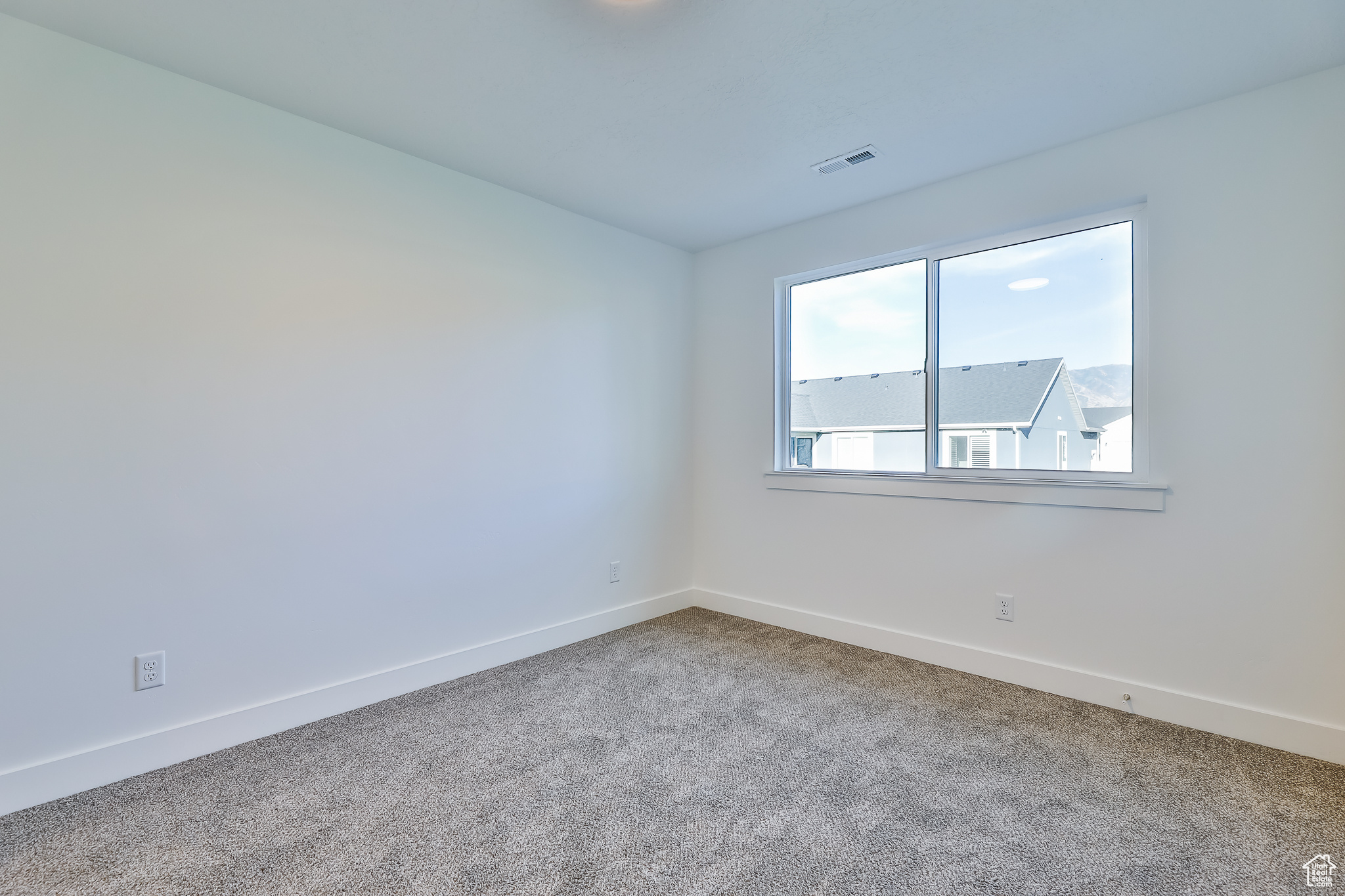 View of carpeted spare room