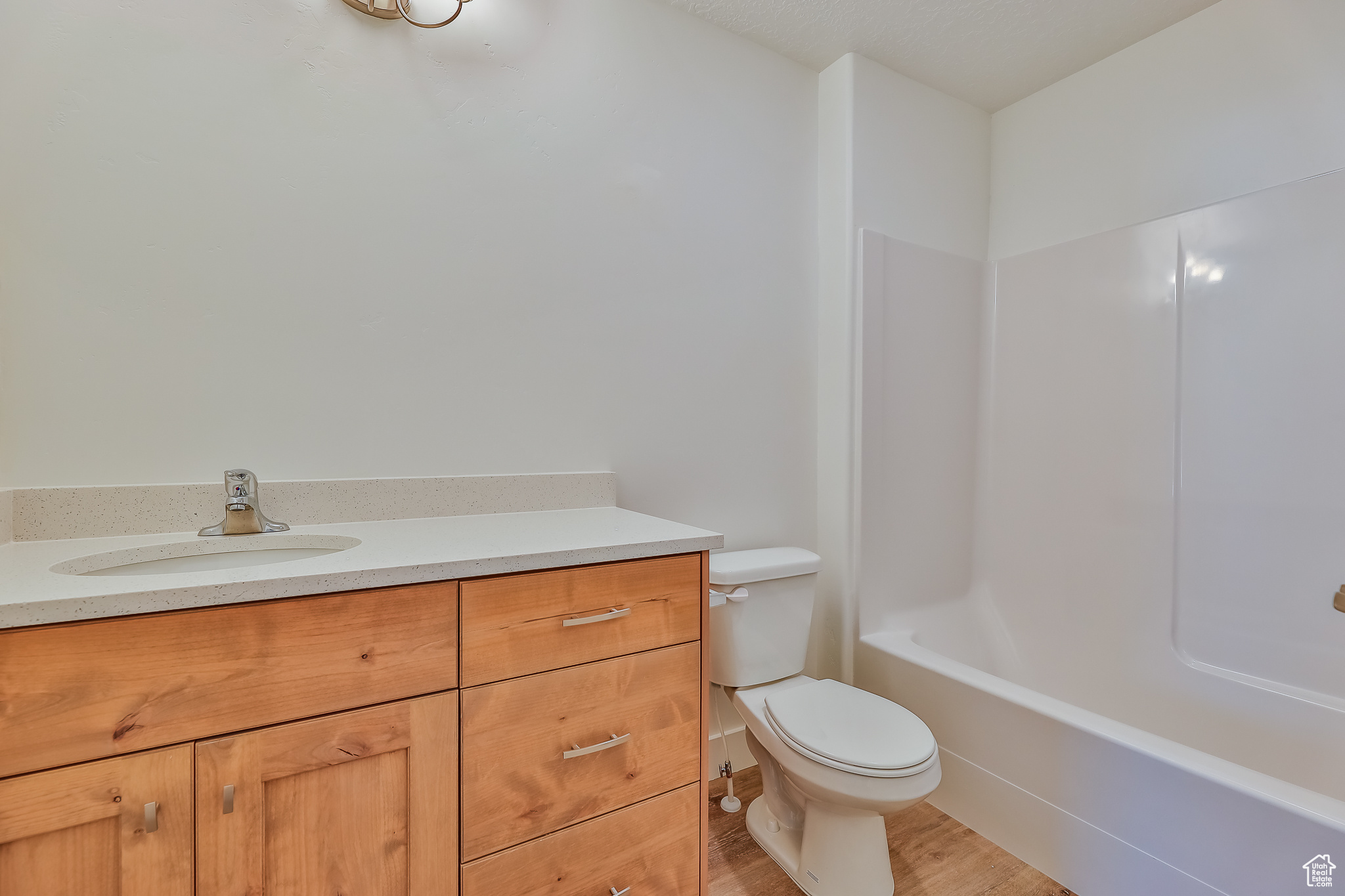 Full bathroom with vanity, toilet, bathing tub / shower combination, and wood-type flooring
