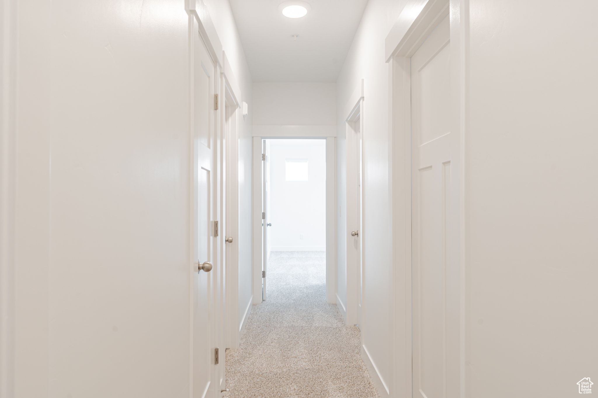 Hallway with light carpet