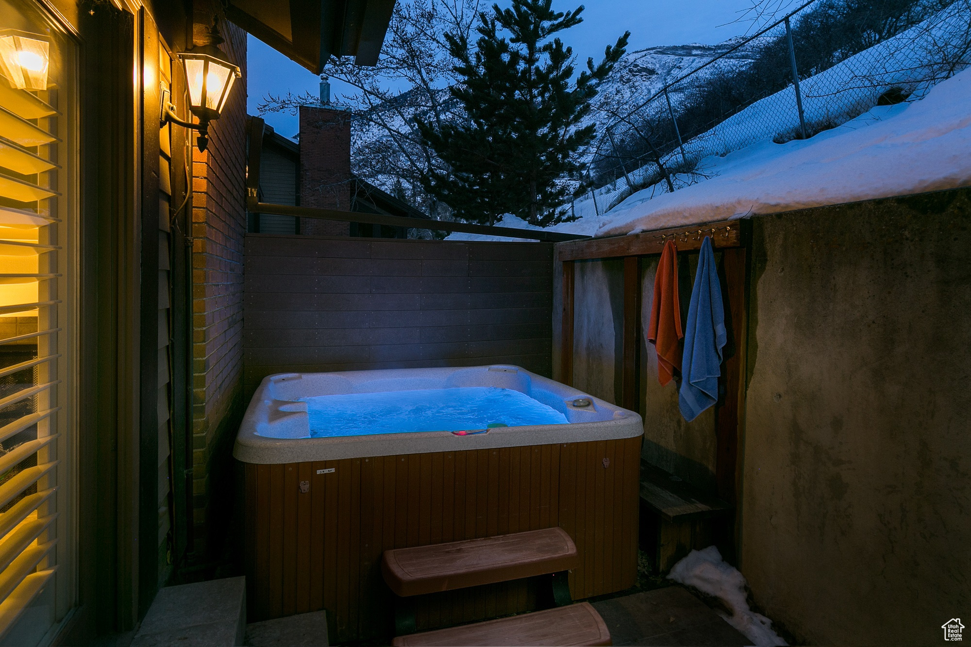 Snow covered patio featuring a hot tub (hot tub can be running and serviced for an additional $200/month).