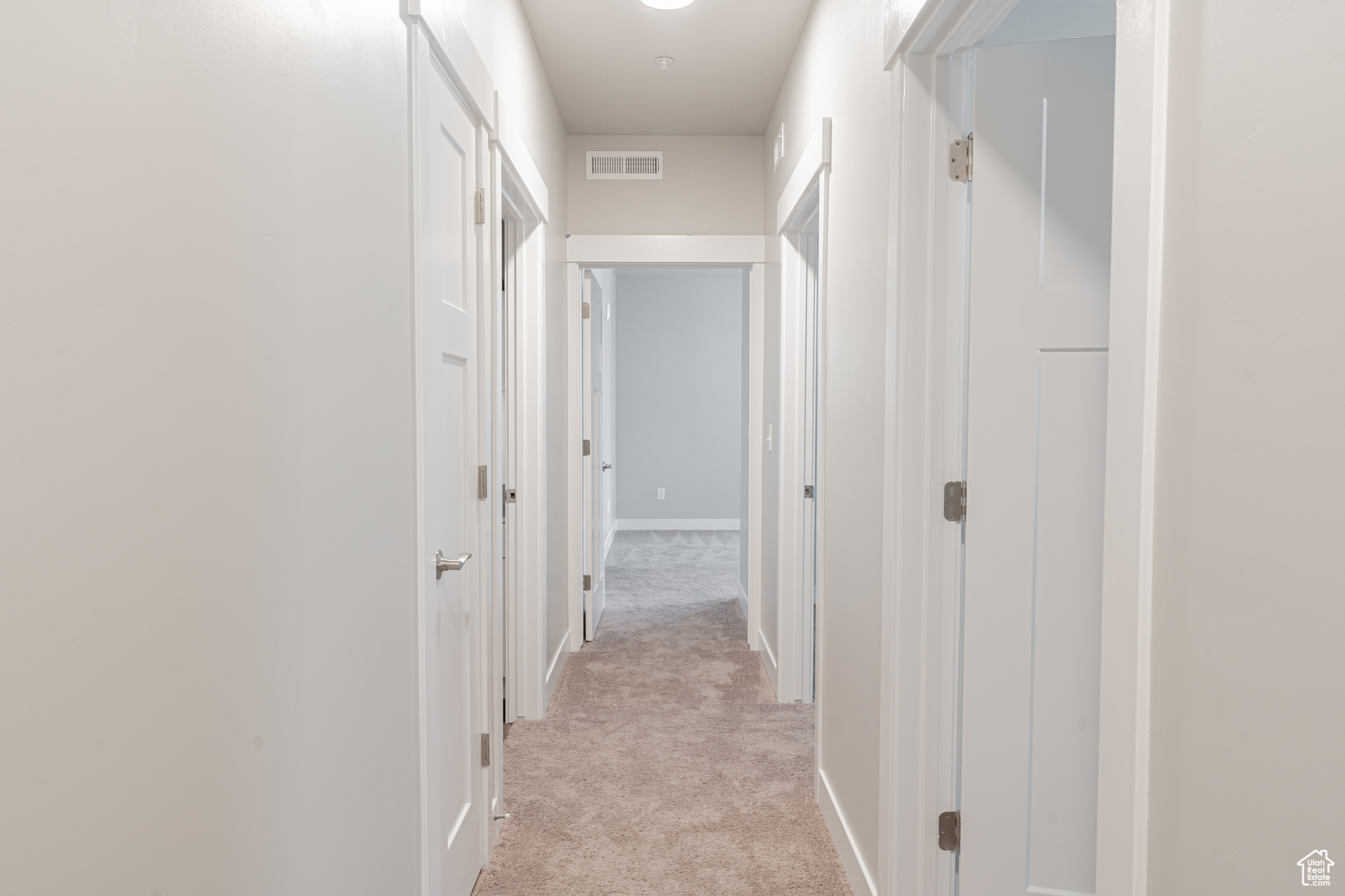 Hallway with light carpet