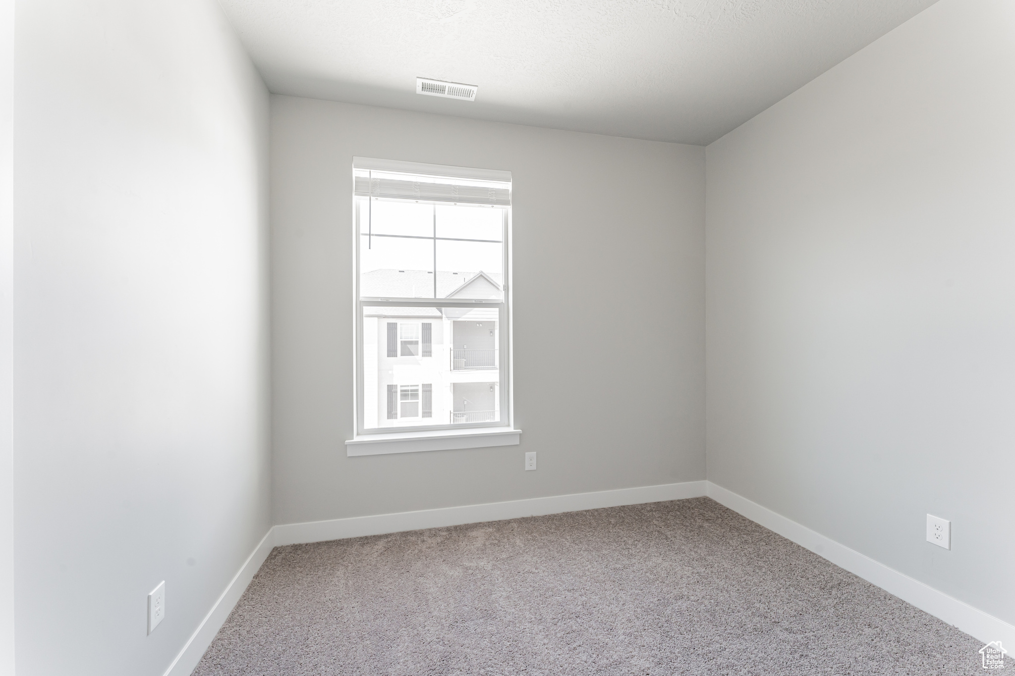 Empty room with carpet flooring