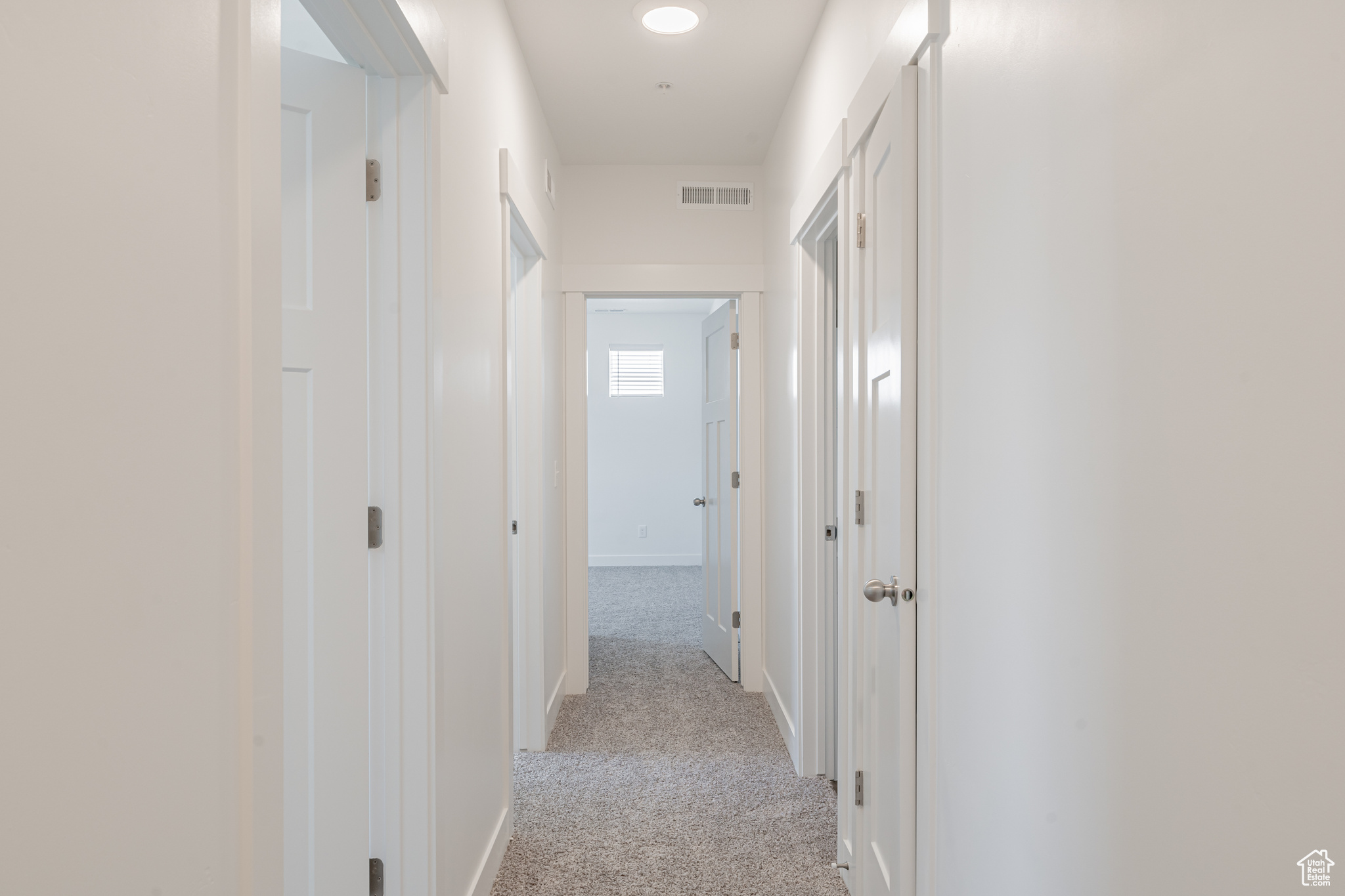 Corridor with light colored carpet