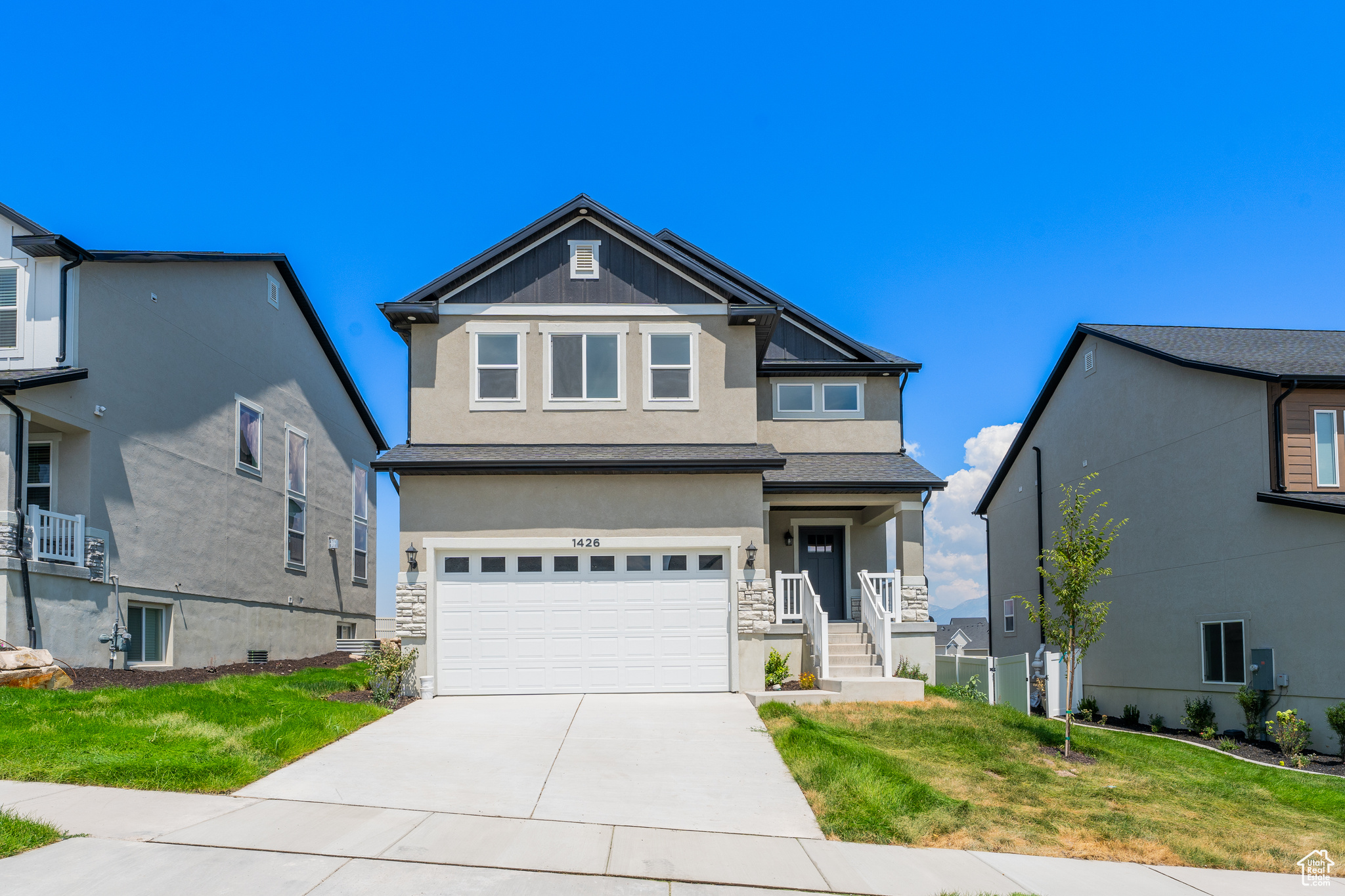 View of front of house featuring a garage and a front lawn