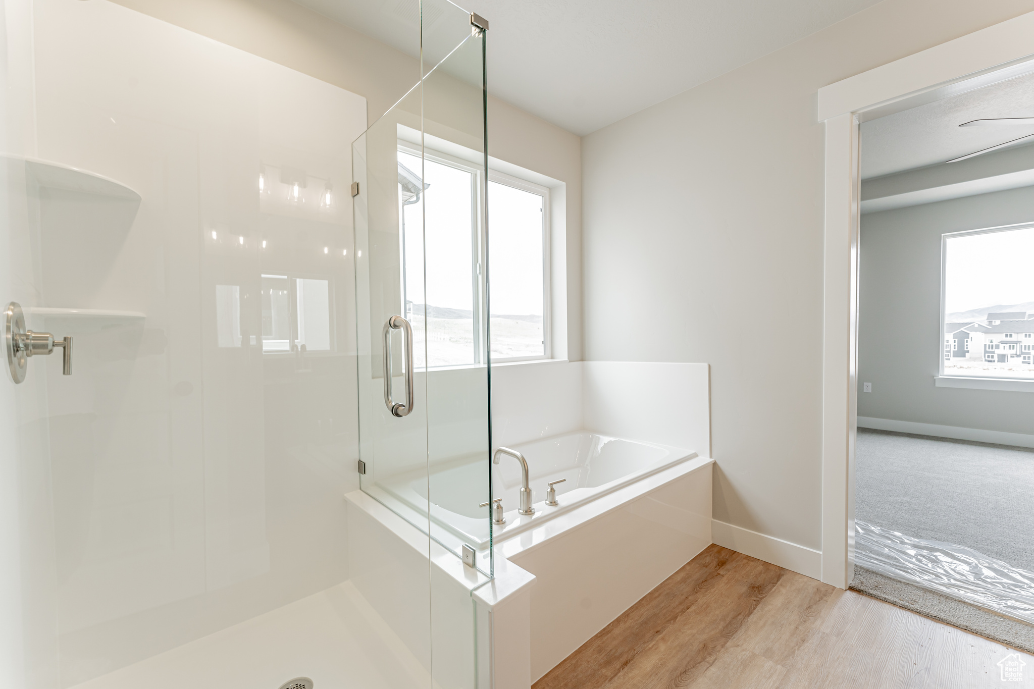 Bathroom with wood-type flooring and plus walk in shower