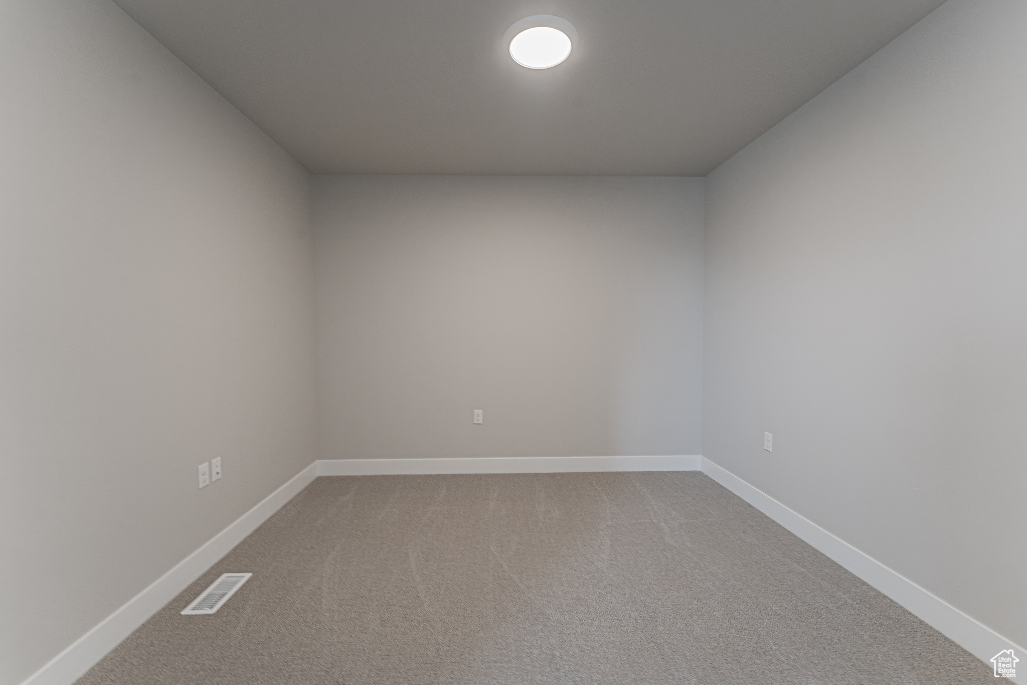 Unfurnished room with light carpet