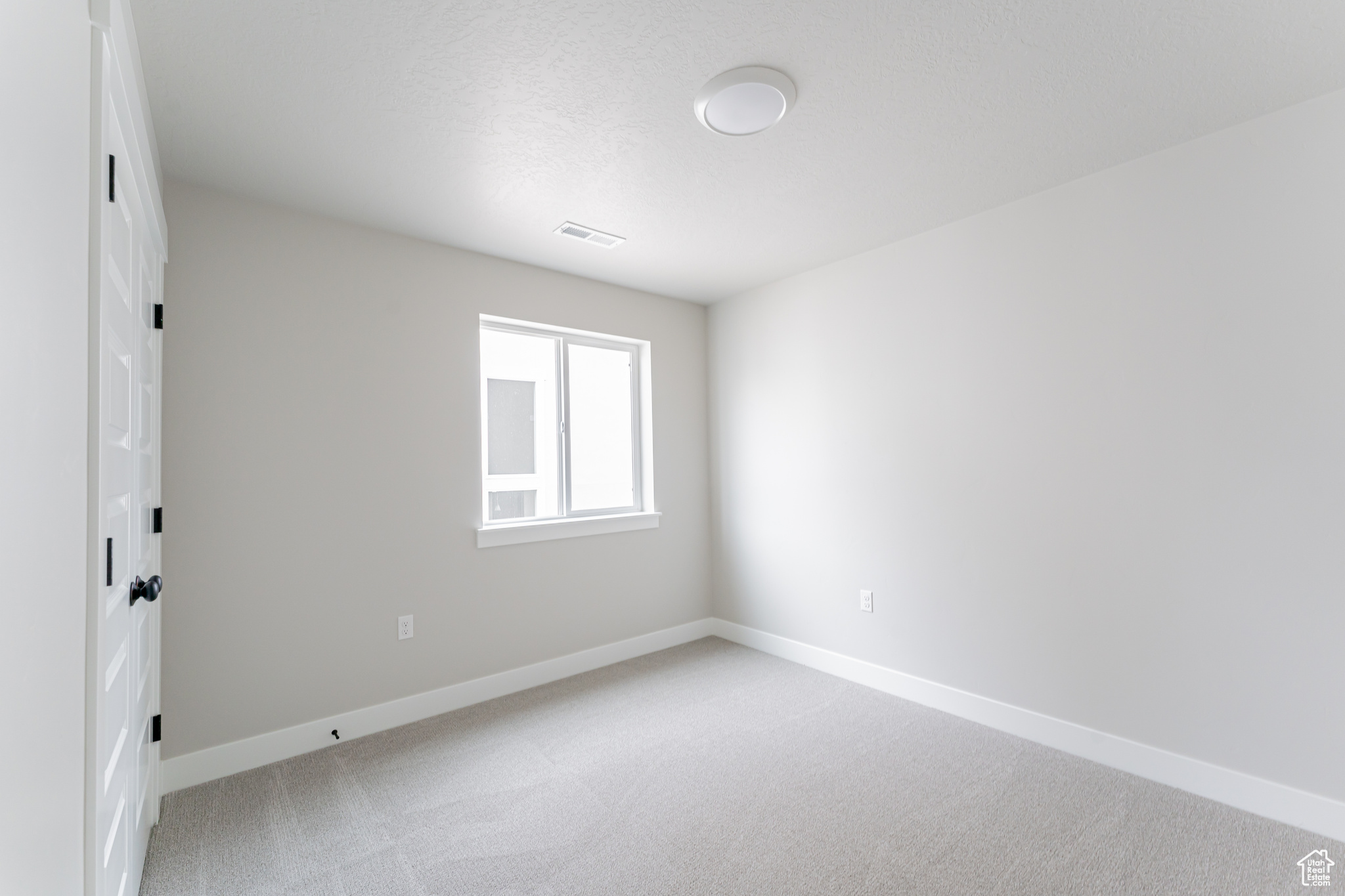 Spare room with light colored carpet