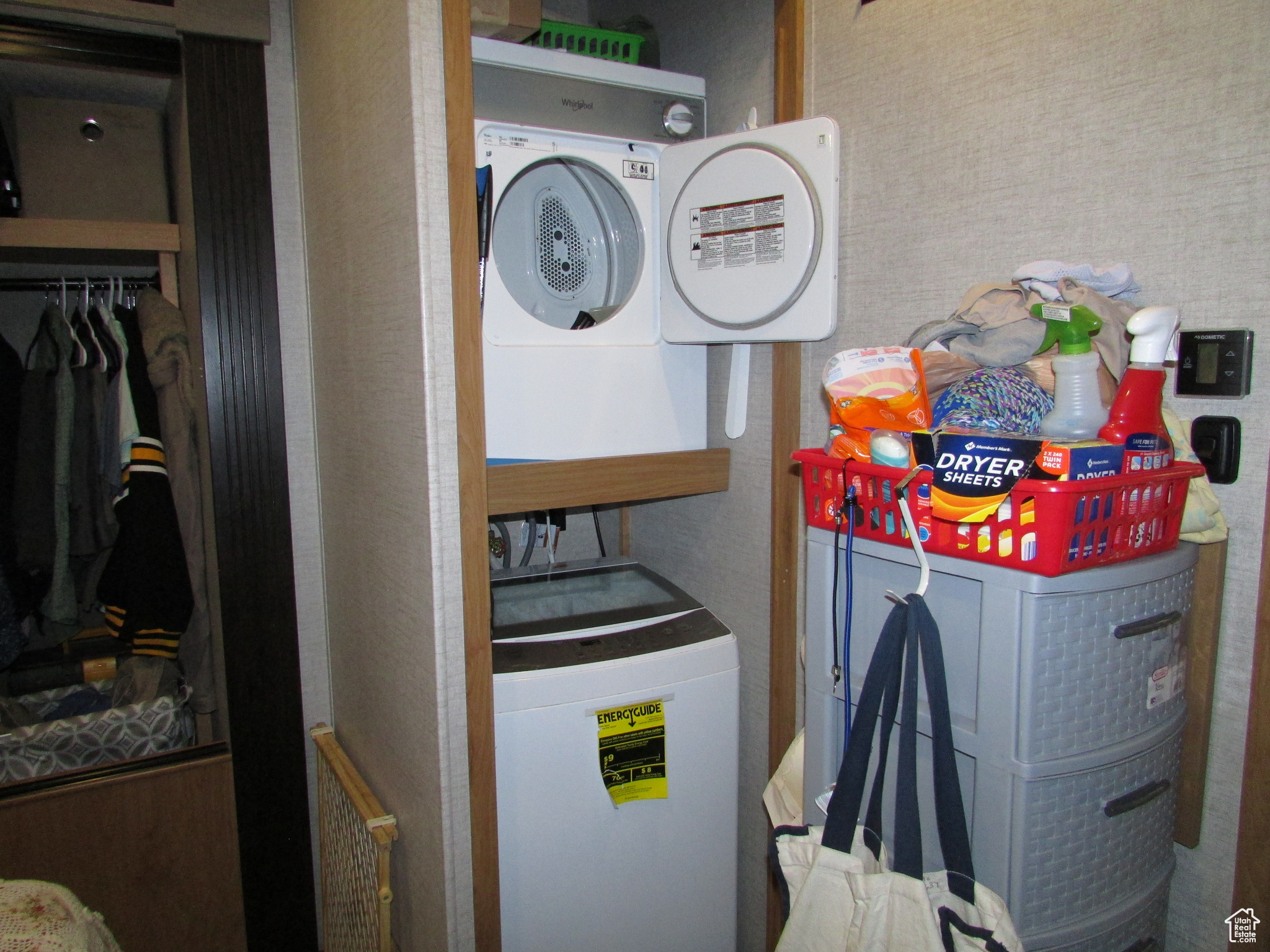 Clothes washing area featuring washer and clothes dryer and water heater