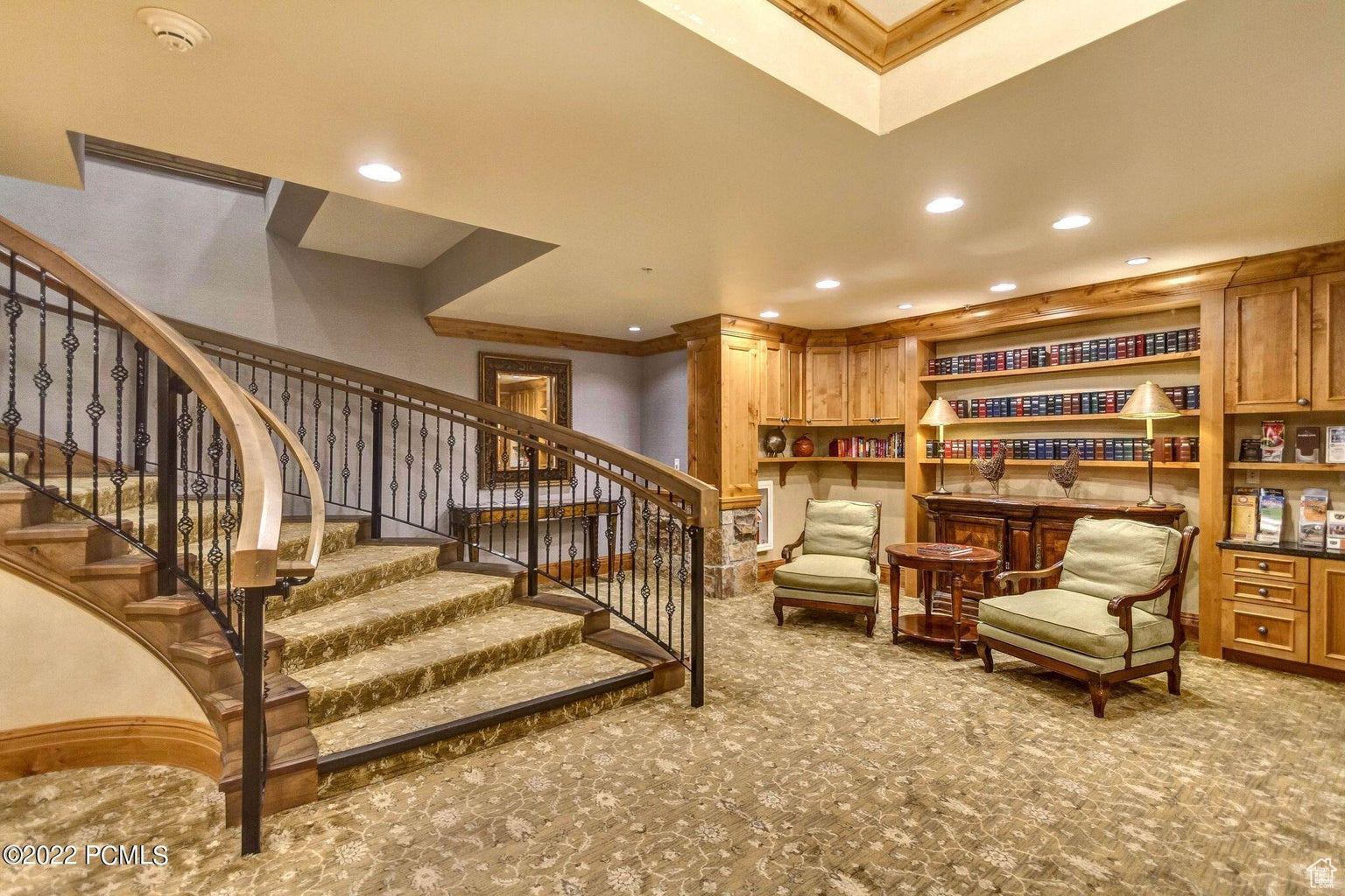 Sitting room with light carpet and ornamental molding