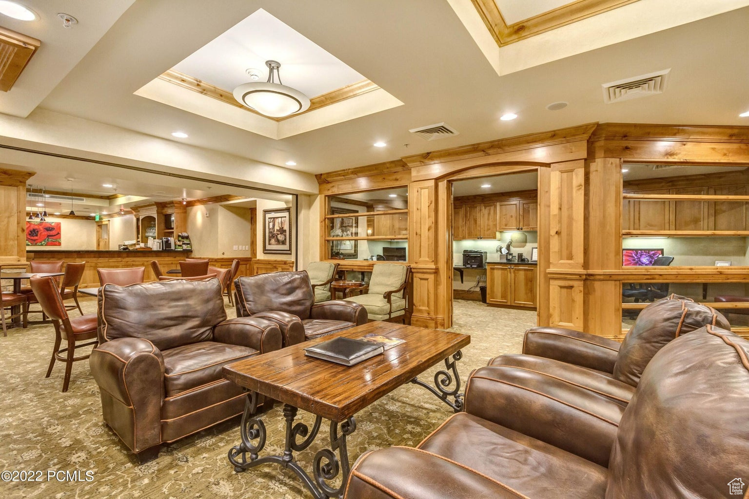 Living room featuring light carpet and a tray ceiling