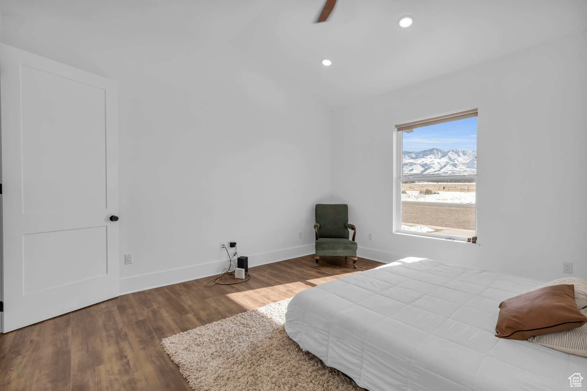 Bedroom with lofted ceiling, ceiling fan, and wood-type flooring