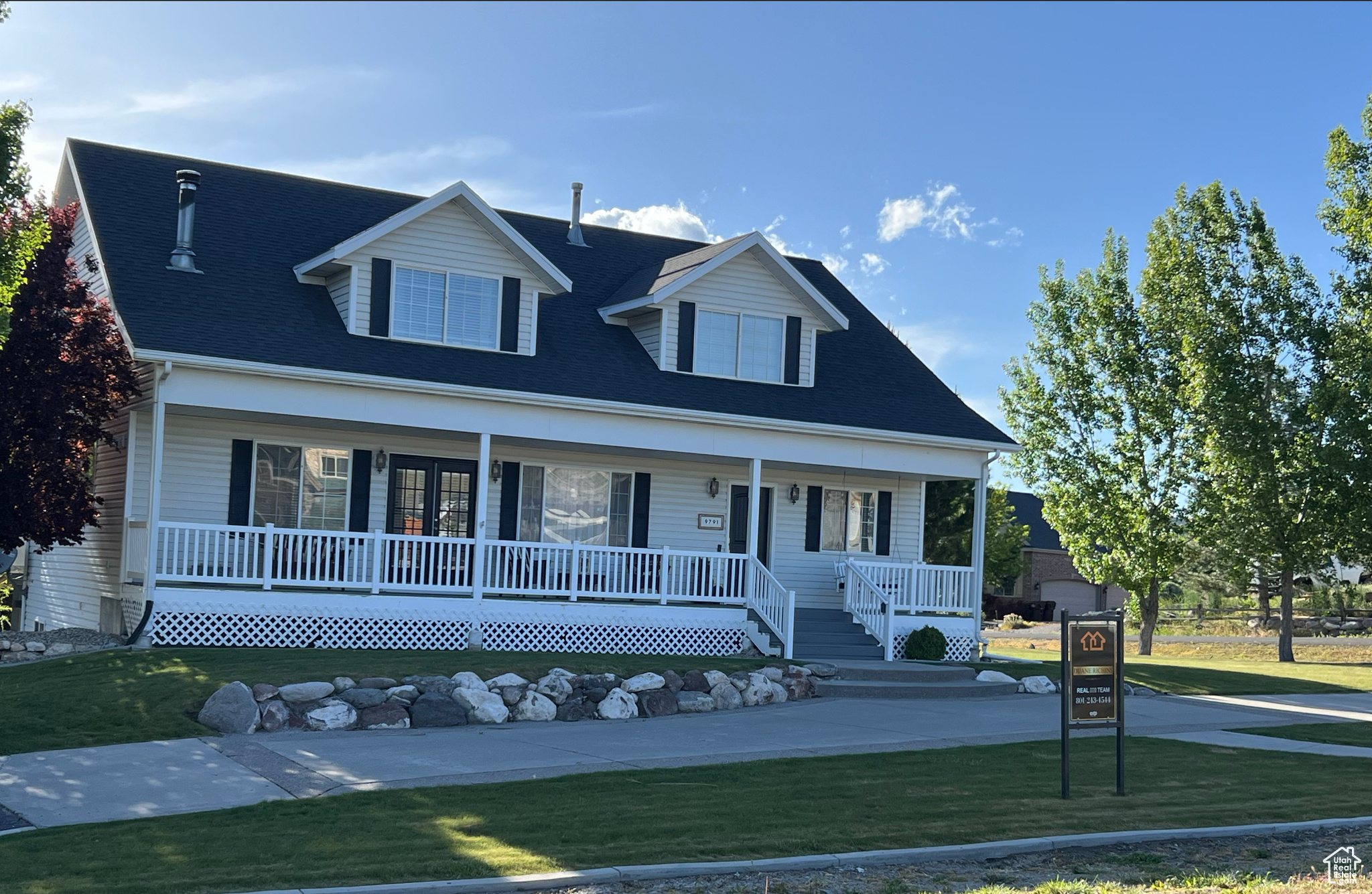 View of front of home with a front lawn and covered porch