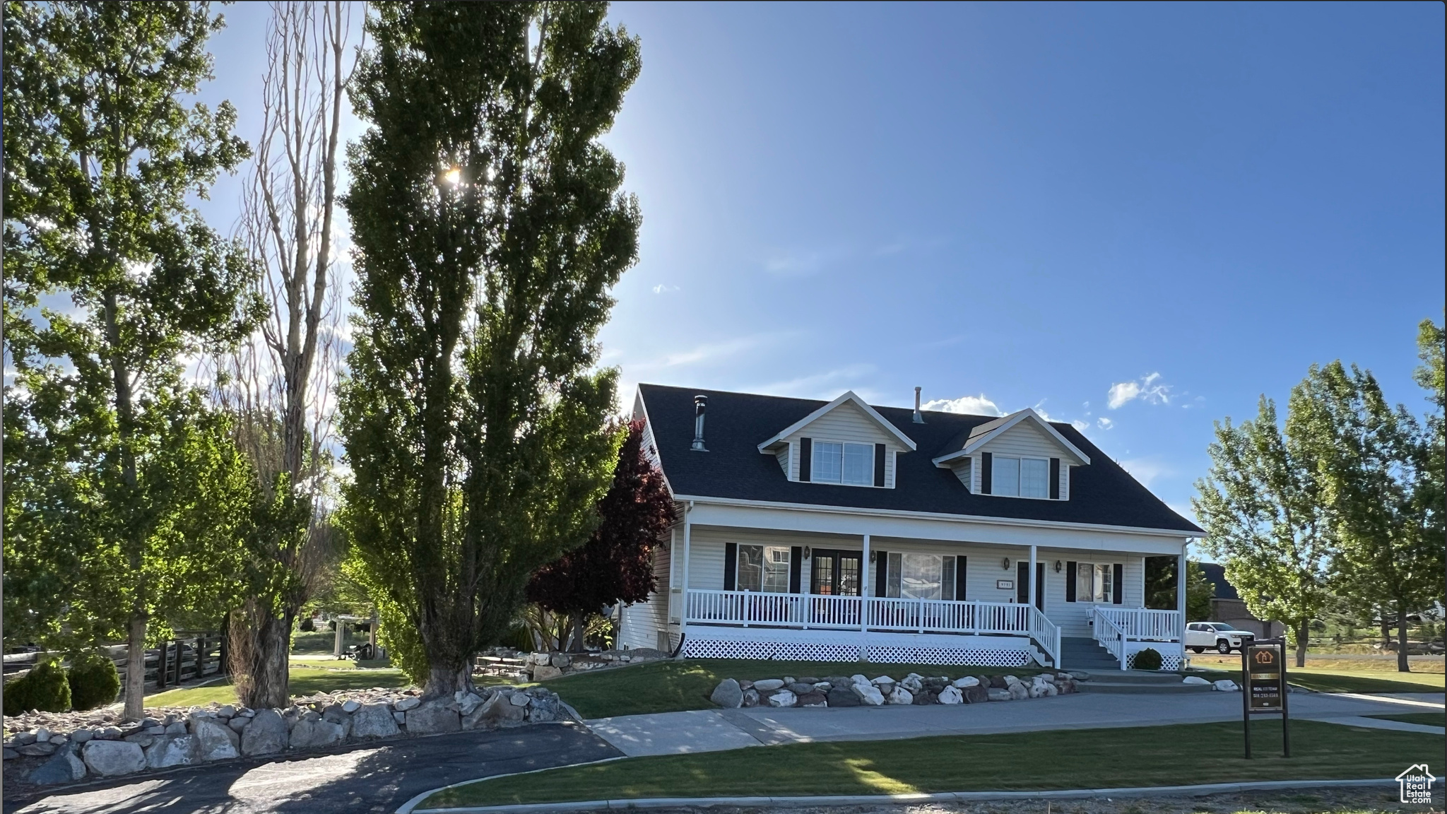 View of front of home featuring a front yard and a porch