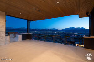 View of patio with a balcony and a mountain view