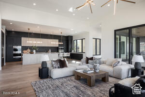 Living room with hardwood / wood-style floors and a towering ceiling