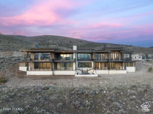 Back house at dusk with a mountain view and a patio