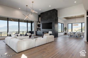 Living room with a notable chandelier, a fireplace, and hardwood / wood-style flooring