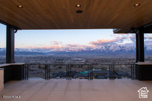 Patio terrace at dusk with a balcony