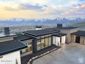 View of front of house featuring a mountain view and a patio area