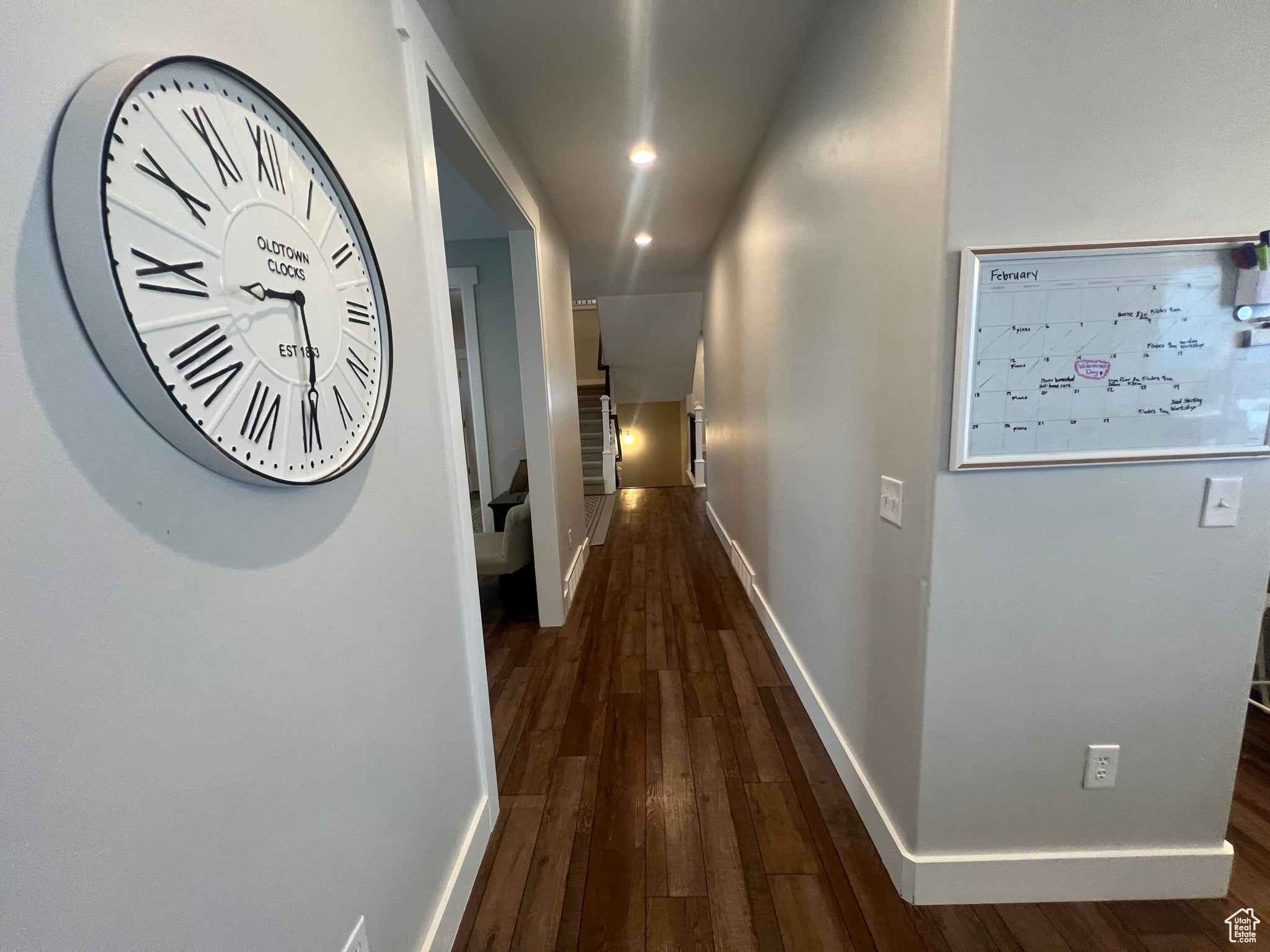 Corridor with dark hardwood / wood-style flooring