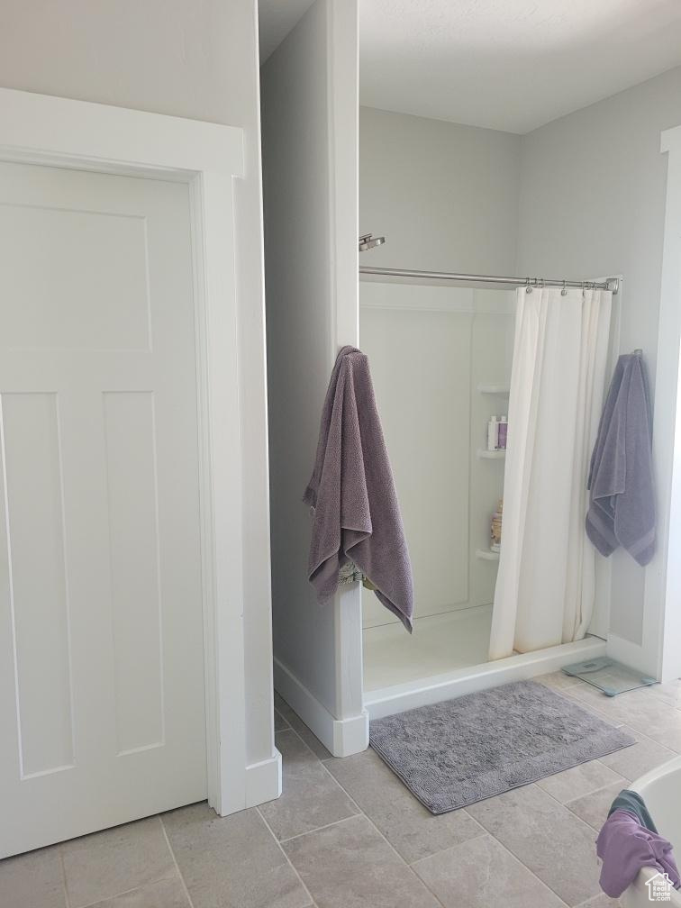 Bathroom with walk in shower and tile floors